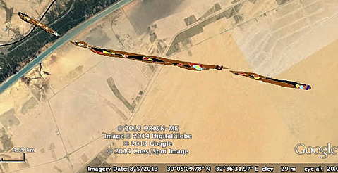 Radar image of long thin streak with multicolor spots showing different materials. Streak is put on top of a aerial picture of sand and roads around lower Suez Canal